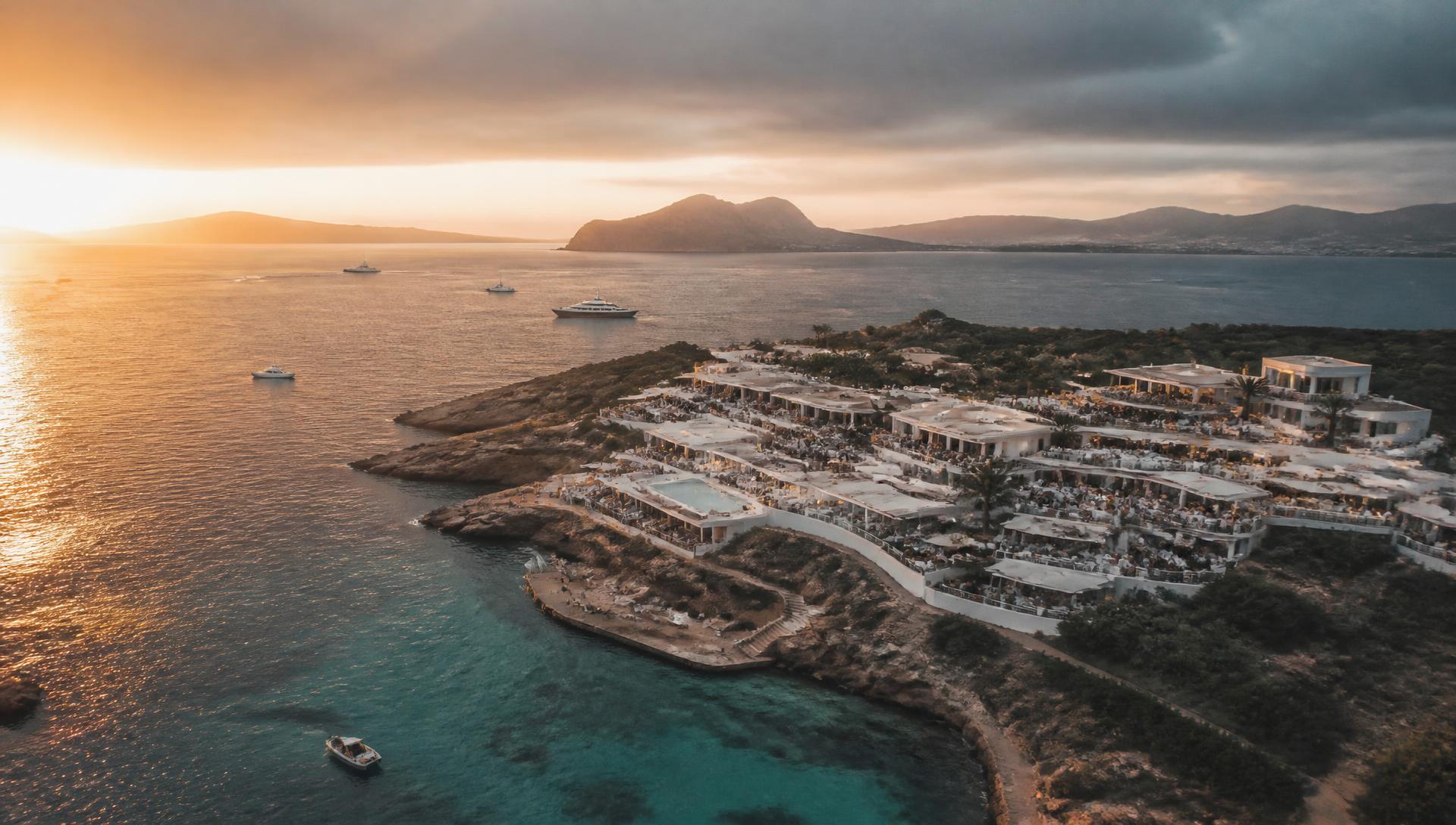 Luxury beach club seen from far above the coastline at golden hour